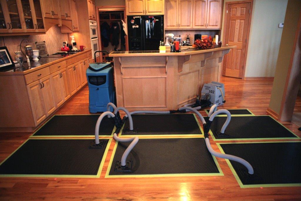 a home experiencing water damage restoration via hardwood floor drying