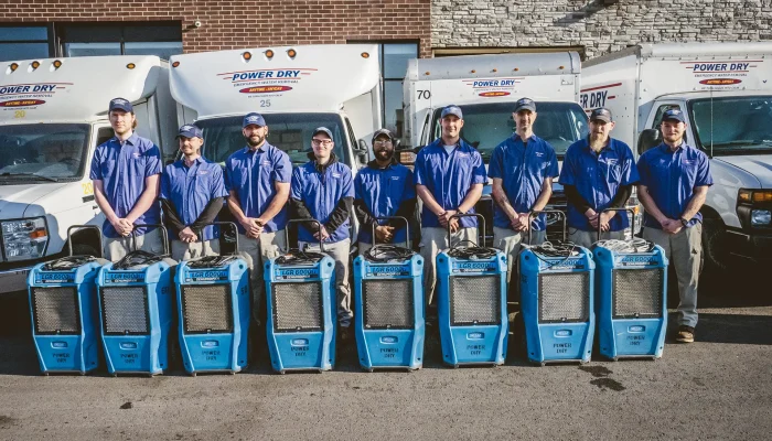 Power Dry Water Damage Restoration Company in Missouri & Kansas standing in front of equipment